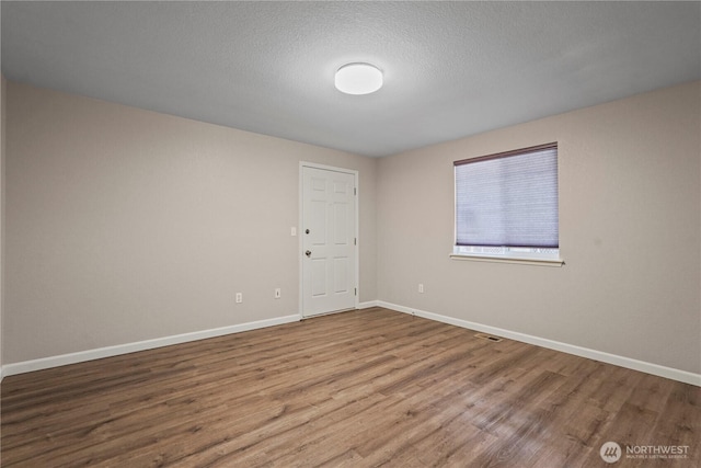 9910 Fairview Lake Rd SW, Port Orchard, WA 98367 - unfurnished room with wood finished floors and a textured ceiling
