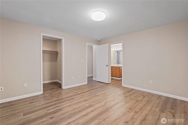 9910 Fairview Lake Rd SW, Port Orchard, WA 98367 - unfurnished bedroom with light wood-style flooring, a closet, a walk in closet, and ensuite bathroom