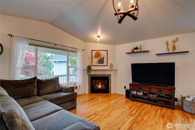 4031 Alyssa Ct, Bellingham, WA 98226 - living area featuring vaulted ceiling, wood finished floors, a chandelier, and a tile fireplace