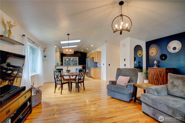4031 Alyssa Ct, Bellingham, WA 98226 - living room with a chandelier, light wood-type flooring, vaulted ceiling, a skylight, and recessed lighting