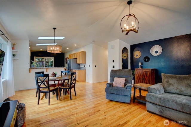 4031 Alyssa Ct, Bellingham, WA 98226 - dining area featuring a chandelier, light wood-style flooring, a skylight, lofted ceiling, and recessed lighting