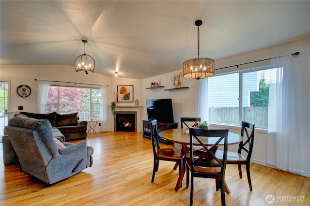 4031 Alyssa Ct, Bellingham, WA 98226 - dining area with a chandelier, plenty of natural light, light wood finished floors, and lofted ceiling