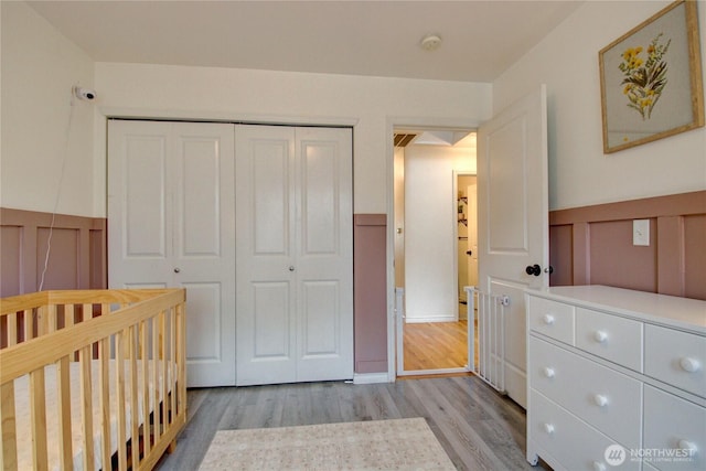 4031 Alyssa Ct, Bellingham, WA 98226 - unfurnished bedroom with a closet, light wood-style flooring, a wainscoted wall, and a decorative wall