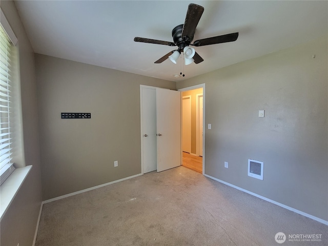 17311 154th Way SE, Yelm, WA 98597 - unfurnished bedroom featuring light carpet and a ceiling fan