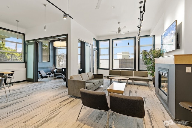 655 Crockett St Unit B304, Seattle, WA 98109 - living area with light wood-type flooring, a ceiling fan, and a glass covered fireplace