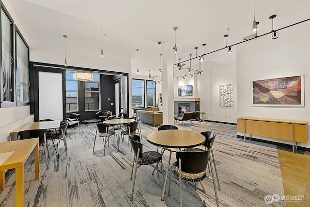 655 Crockett St Unit B304, Seattle, WA 98109 - dining area with a glass covered fireplace, a towering ceiling, and a wall mounted air conditioner