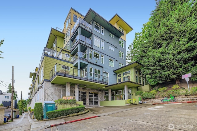 655 Crockett St Unit B304, Seattle, WA 98109 - view of building exterior featuring a garage and concrete driveway