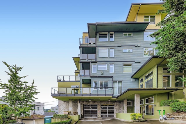 655 Crockett St Unit B304, Seattle, WA 98109 - view of building exterior featuring an attached garage and concrete driveway