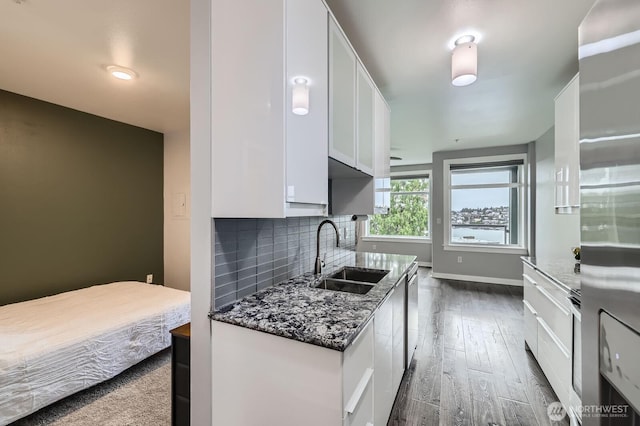 655 Crockett St Unit B304, Seattle, WA 98109 - kitchen with white cabinets, backsplash, dark stone counters, and dishwasher