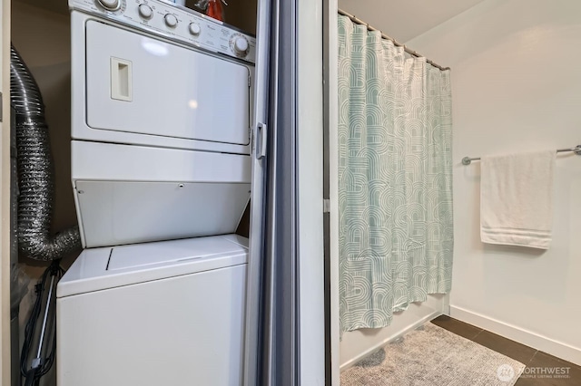 655 Crockett St Unit B304, Seattle, WA 98109 - laundry area featuring stacked washer and clothes dryer and dark tile patterned floors