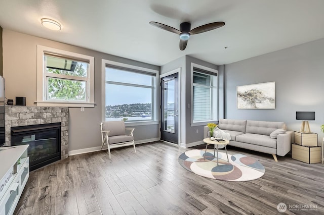 655 Crockett St Unit B304, Seattle, WA 98109 - living area with wood finished floors, a stone fireplace, and a ceiling fan