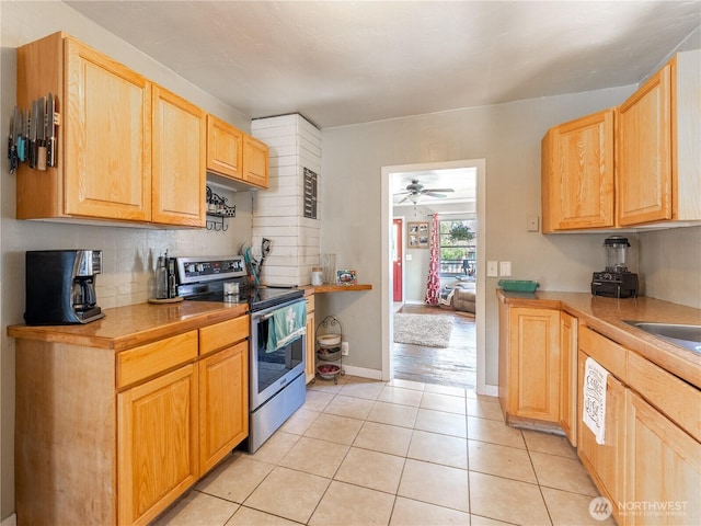1018 Vassar Ave, Wenatchee, WA 98801 - kitchen featuring stainless steel electric range, light tile patterned floors, backsplash, light countertops, and light brown cabinetry