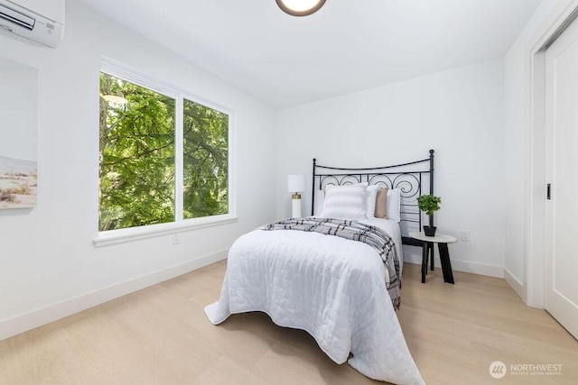 2216 18th Ave S, Seattle, WA 98144 - bedroom with an AC wall unit and light wood-style flooring