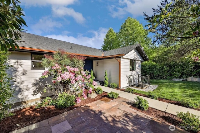 2216 18th Ave S, Seattle, WA 98144 - view of front of house featuring a patio, a front yard, and roof with shingles