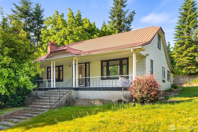 212 SE Cowlitz Rd, Winlock, WA 98596 - view of front of home featuring a chimney, a porch, and a metal roof
