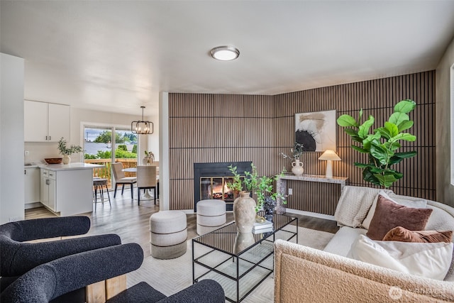 1415S 93rd St, Tacoma, WA 98444 - living area featuring light wood-style flooring, a glass covered fireplace, and a chandelier