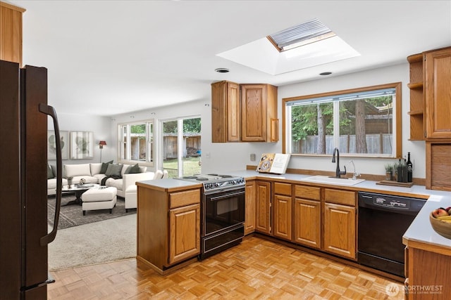 17722 6th Ave W, Bothell, WA 98012 - kitchen with black appliances, a skylight, open floor plan, a peninsula, and plenty of natural light