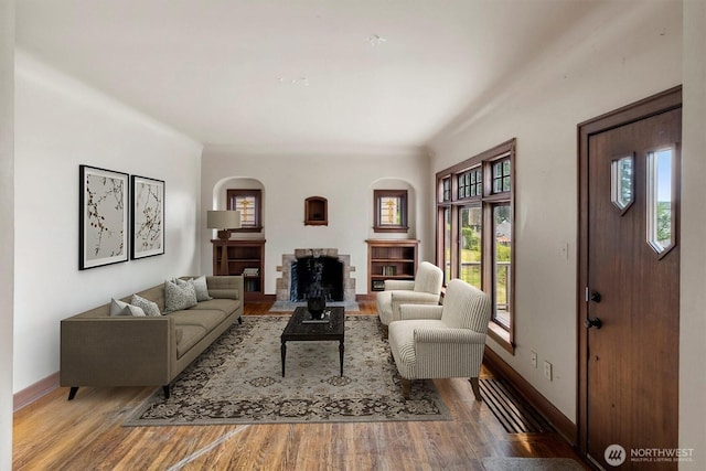 720 N Forest St, Bellingham, WA 98225 - living room featuring wood finished floors, arched walkways, and a fireplace
