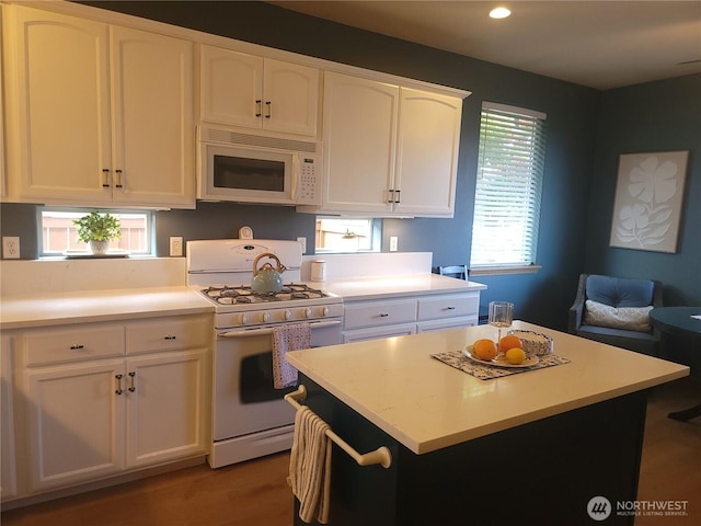8542 Bainbridge Loop NE, Lacey, WA 98516 - kitchen with white appliances, white cabinets, light countertops, plenty of natural light, and recessed lighting