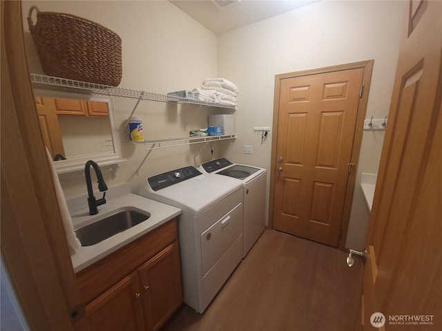 8542 Bainbridge Loop NE, Lacey, WA 98516 - laundry room with independent washer and dryer, wood finished floors, and cabinet space