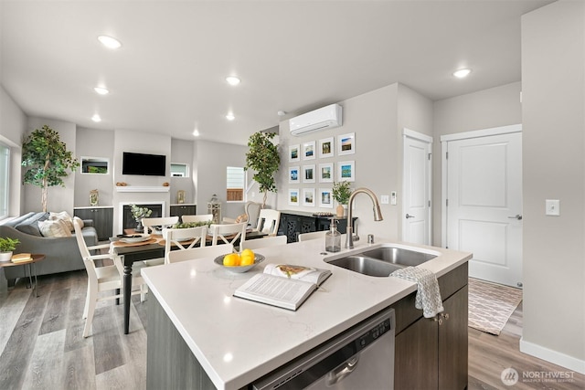 2649 Sandwood Ln, Blaine, WA 98230 - kitchen with a wall mounted AC, stainless steel dishwasher, light wood-style flooring, open floor plan, and a kitchen island with sink