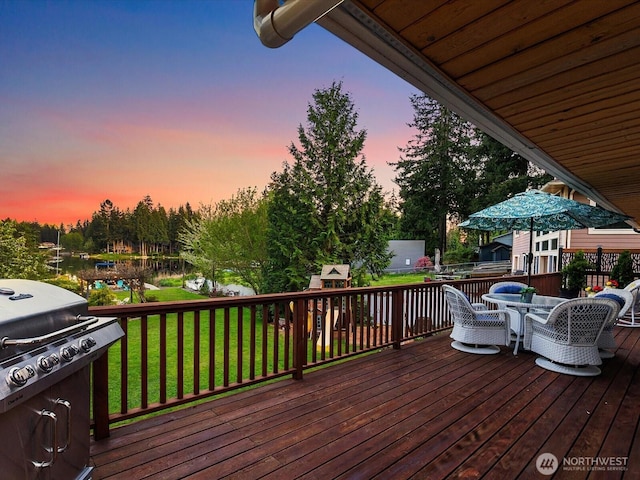 31707 W Lake Ketchum Rd, Stanwood, WA 98292 - wooden terrace featuring outdoor dining area, a lawn, and area for grilling