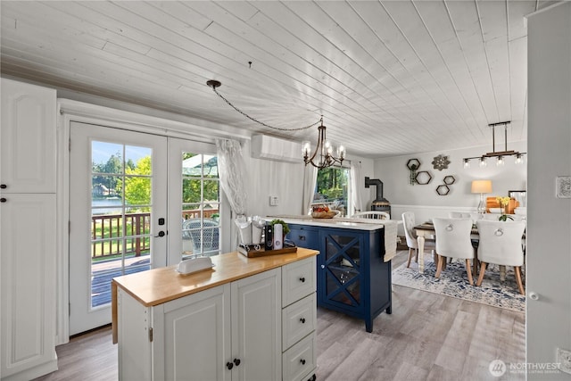31707 W Lake Ketchum Rd, Stanwood, WA 98292 - kitchen with wood counters, wooden ceiling, blue cabinets, a center island, and plenty of natural light