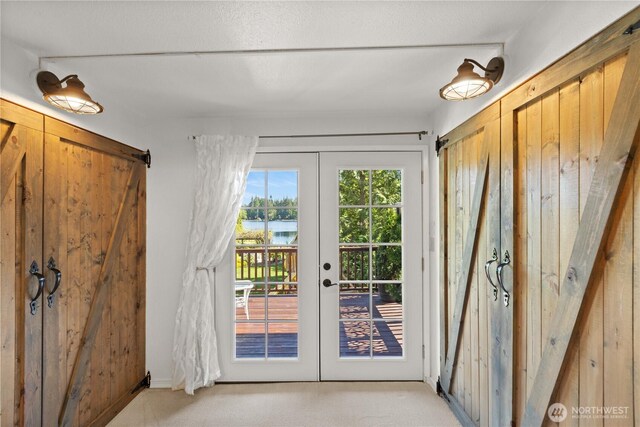 31707 W Lake Ketchum Rd, Stanwood, WA 98292 - foyer with french doors, light colored carpet, and a water view