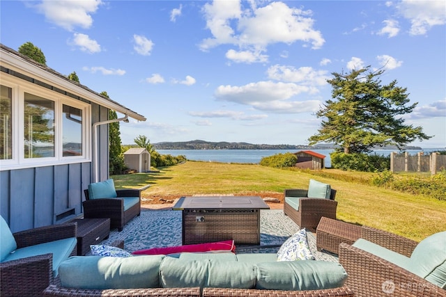4448 S Shore Dr, Anacortes, WA 98221 - view of patio with a shed, an outdoor living space, and a water view