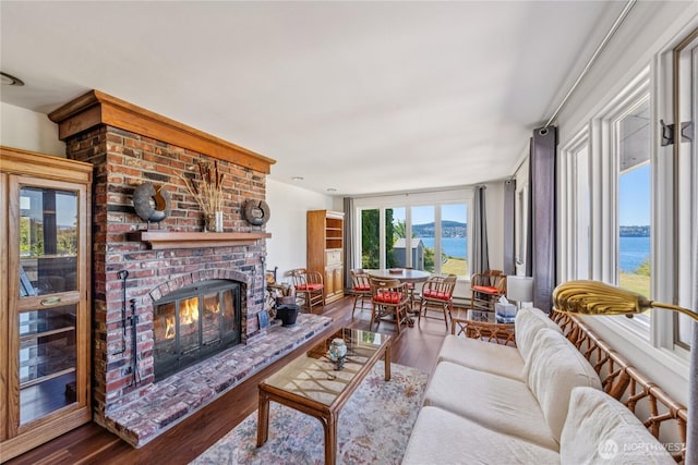 4448 S Shore Dr, Anacortes, WA 98221 - living area featuring a water view, wood finished floors, and a fireplace