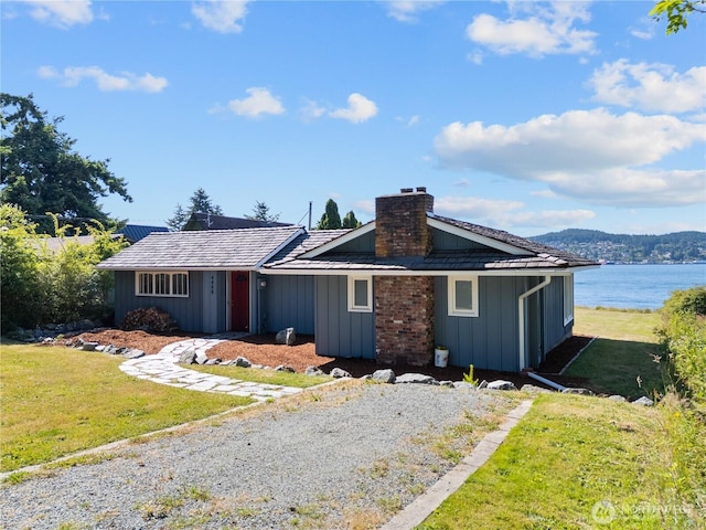 4448 S Shore Dr, Anacortes, WA 98221 - single story home with a chimney, a front yard, board and batten siding, and a water view
