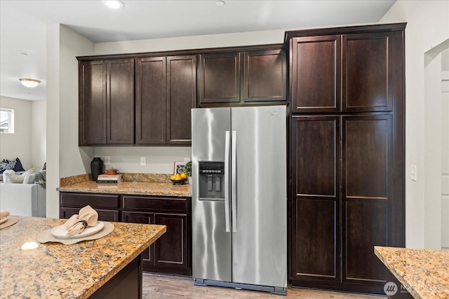 14222 56th Pl W, Edmonds, WA 98026 - kitchen featuring stainless steel fridge with ice dispenser, light stone counters, light wood-style floors, and dark brown cabinetry