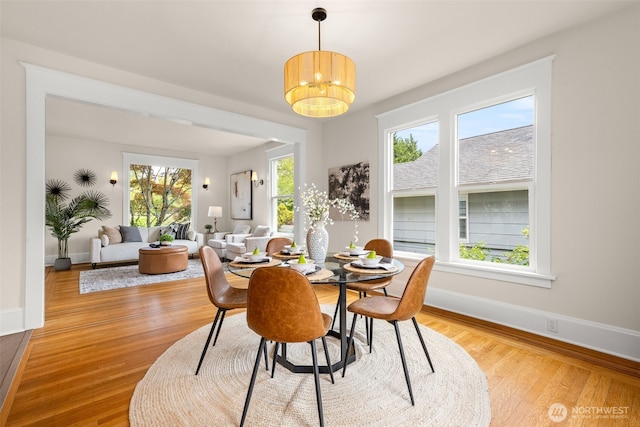 8251 Densmore Ave N, Seattle, WA 98103 - dining space featuring light wood-style flooring and a chandelier