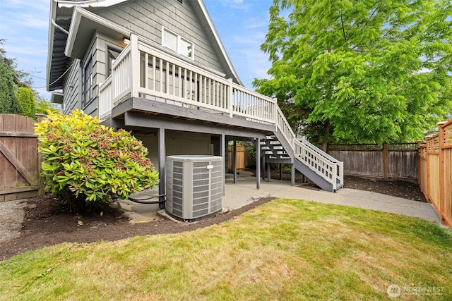 8251 Densmore Ave N, Seattle, WA 98103 - rear view of house featuring a fenced backyard, a wooden deck, a patio, and stairs