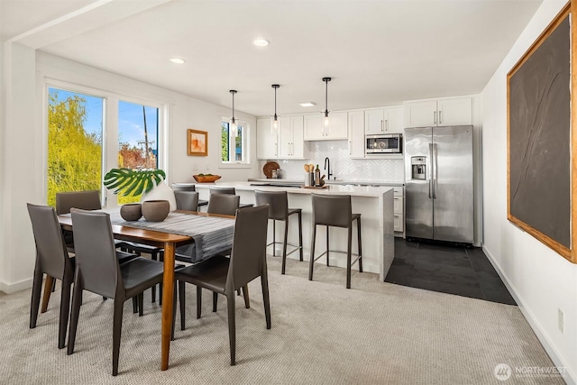2301 Fairview Ave E Unit 301, Seattle, WA 98102 - carpeted dining space with recessed lighting and a sink