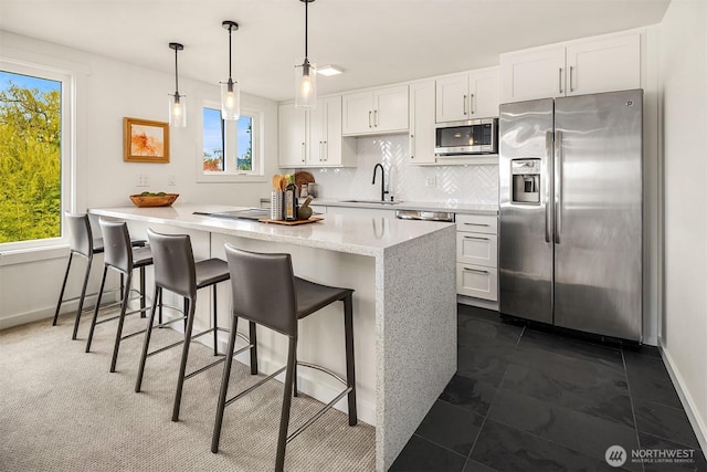 2301 Fairview Ave E Unit 301, Seattle, WA 98102 - kitchen with stainless steel appliances, healthy amount of natural light, and white cabinetry