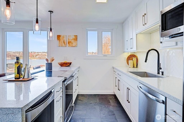 2301 Fairview Ave E Unit 301, Seattle, WA 98102 - kitchen featuring stainless steel appliances, light stone countertops, and white cabinets