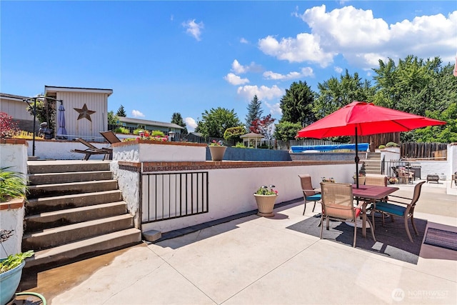 1220 SE 2nd St, East Wenatchee, WA 98802 - view of patio featuring a storage unit and outdoor dining area
