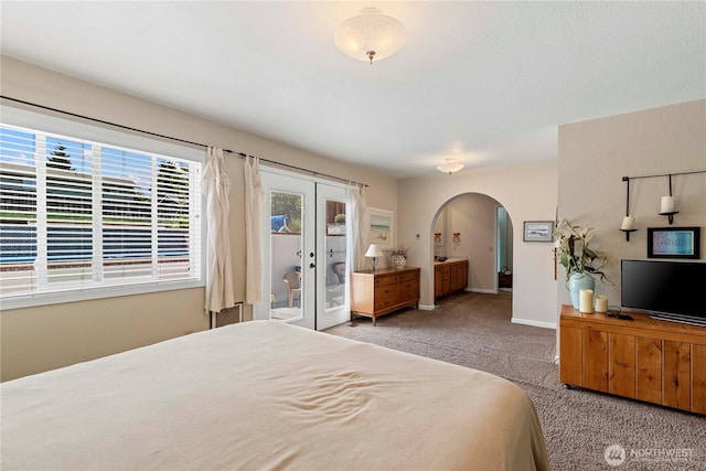 1220 SE 2nd St, East Wenatchee, WA 98802 - carpeted bedroom featuring arched walkways, access to exterior, french doors, and ensuite bathroom