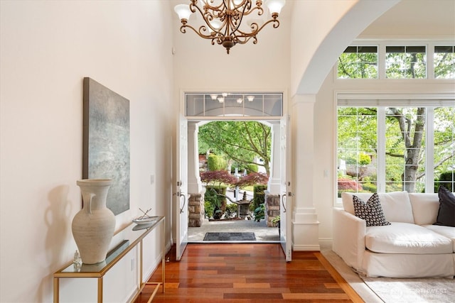 1206 S 36th Pl, Renton, WA 98055 - foyer with arched walkways, wood finished floors, a chandelier, and a towering ceiling