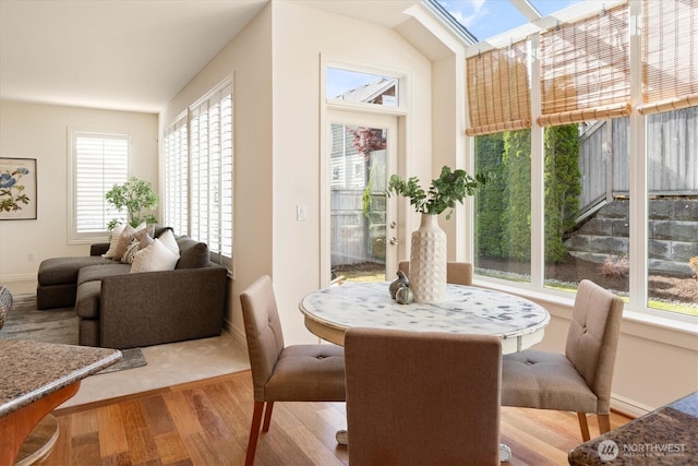 1206 S 36th Pl, Renton, WA 98055 - dining space with wood finished floors and a skylight