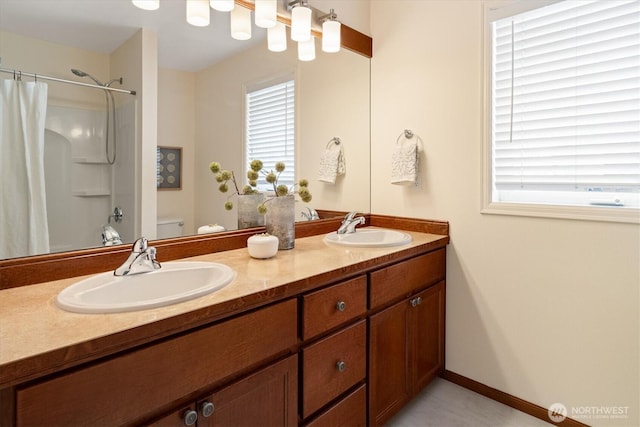 1206 S 36th Pl, Renton, WA 98055 - full bathroom with curtained shower, double vanity, and healthy amount of natural light