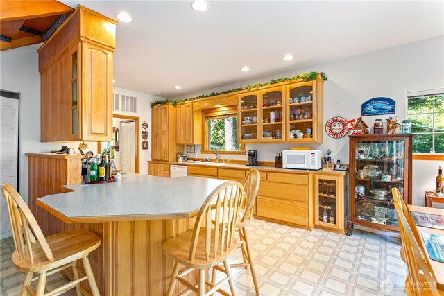 9204 Silver Lake Rd, Maple Falls, WA 98266 - kitchen featuring white appliances, healthy amount of natural light, a breakfast bar area, light flooring, and recessed lighting
