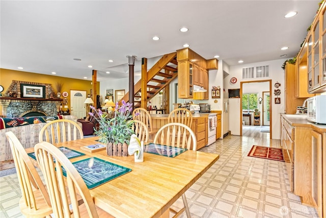9204 Silver Lake Rd, Maple Falls, WA 98266 - dining space featuring light floors, recessed lighting, and a fireplace