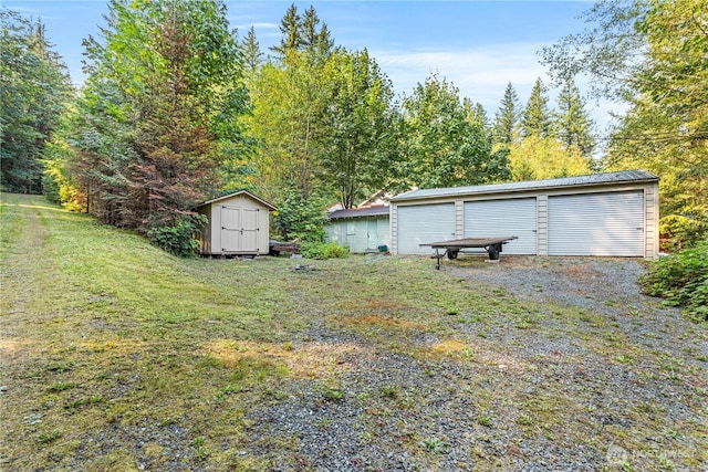 9204 Silver Lake Rd, Maple Falls, WA 98266 - view of grassy yard with a storage unit and a detached garage