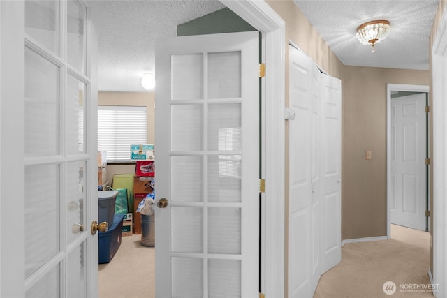 1541 Sheridan Unit C2, Bremerton, WA 98310 - hallway featuring a textured ceiling, light colored carpet, and french doors