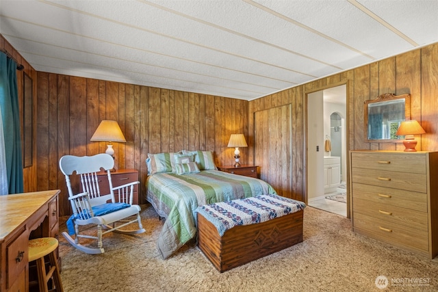2641 Scotlac Dr SW, Olympia, WA 98512 - bedroom featuring carpet flooring, wood walls, arched walkways, a textured ceiling, and connected bathroom