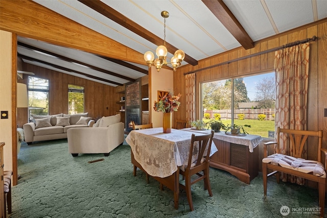 2641 Scotlac Dr SW, Olympia, WA 98512 - dining room with carpet floors, wooden walls, a chandelier, and a large fireplace