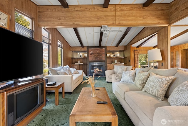 2641 Scotlac Dr SW, Olympia, WA 98512 - carpeted living area with wooden walls, beamed ceiling, ceiling fan, and a fireplace