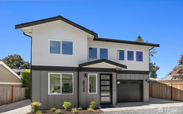 8526 Latona Ave NE, Seattle, WA 98115 - contemporary home featuring board and batten siding, a garage, and driveway